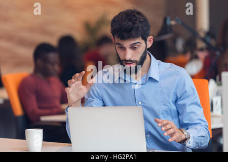 frustrated young business man working on desktop computer Stock Photo