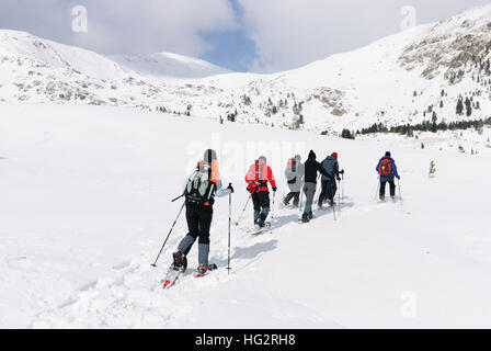 Obdach: Snowshoe hikers in front of Mount Zirbitzkogel in the Seetaler Alps, Murtal, Steiermark, Styria, Austria Stock Photo