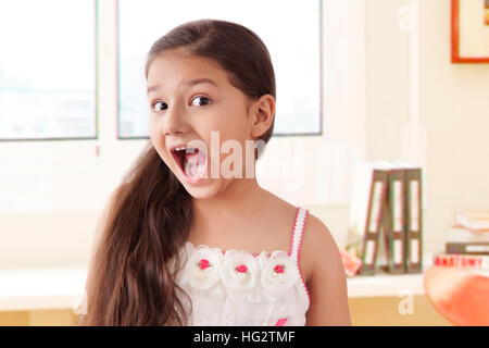 Portrait of smiling girl pulling funny faces Stock Photo