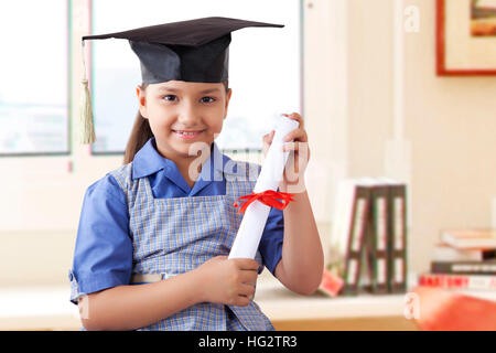Girl wearing graduation cap and holding diploma Stock Photo