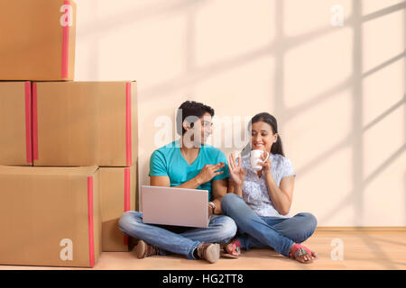 Couple having coffee at new home Stock Photo