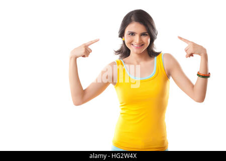 Curly haired model with winter clothes pointing out her head Stock Photo