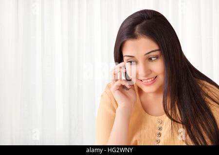 Smiling woman talking on cell phone Stock Photo
