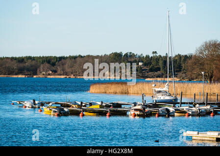 Ronneby, Sweden - January 2, 2017: Documentary of coastal lifestyle. The Ekenas marina with small leisure crafts tied to the piers. Coastal landscape Stock Photo