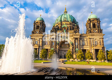 Picturesque view of Berlin Cathedral (Berliner Dom) in sunny summer day. Berlin city, Germany. Modemer Brunnen fountain on the foreground Stock Photo