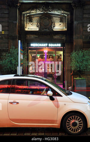 The entrance to trendy Merchant Square, once 18th century tobacco warehouses, now cool restaurants and bars, in Glasgow, UK Stock Photo