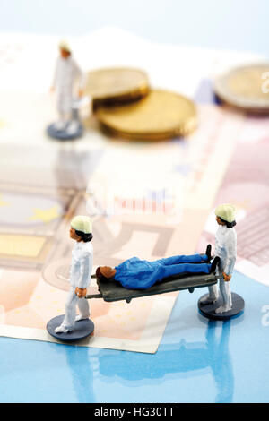 Paramedics carrying stretcher with money in background: symbol for medical costs Stock Photo