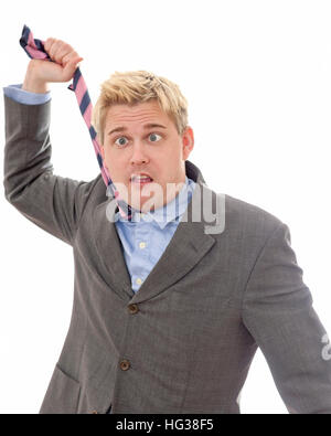 Crazy businessman gone mad strangling himself with his necktie isolated on white background  Model Release: Yes.  Property Release: No. Stock Photo