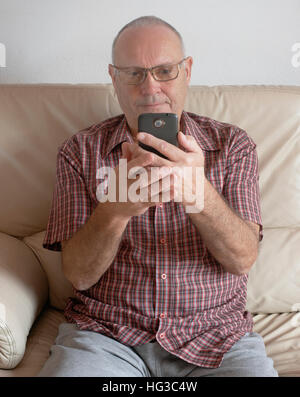 Senior Mature Man using a Smart Phone Stock Photo
