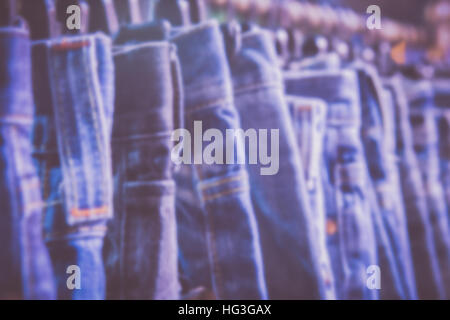 Blurred of  row of hanged blue jeans in a shop Stock Photo