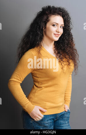 Pretty smiling girl standing in semi position Stock Photo