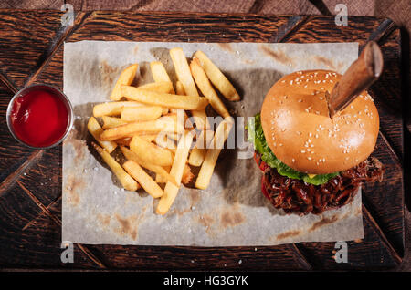 Top view of burger and French fries standing on table Stock Photo
