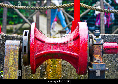 old and rusty gear pulley of a metal which was used to hoist the anchor of a ship Stock Photo