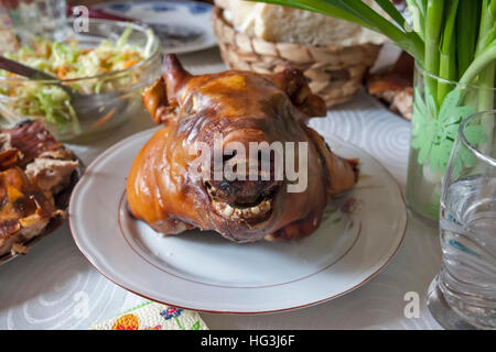 Pigs head on barbique at plate on the table Stock Photo