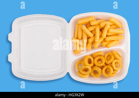 top view of junk food ingredients in a white take away packaging box on blue background, calories concept Stock Photo