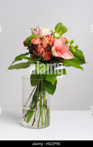 flower arrangement on table. Bouquet of roses in vase. White background. Stock Photo