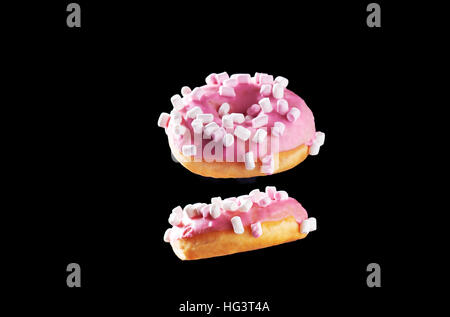 Two donuts in motion isolated on black Stock Photo