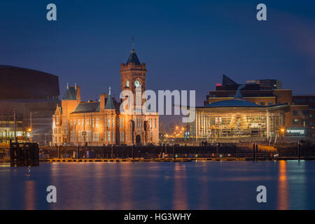 Pierhead building and Y Senedd (Welsh Assembly building) lit at night, Cardiff Bay, Glamorgan, Wales, UK Stock Photo