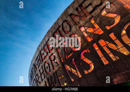 Cardiff's Wales Millennium Centre arts complex lit in early evening, Cardiff Bay, Glamorgan, Wales, UK Stock Photo