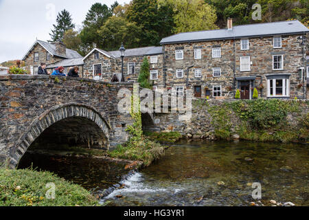 Bridge over the River Colwyn and the Prince Llewelyn Hotel at Beddgelert, Snowdonia, North Wales. Stock Photo