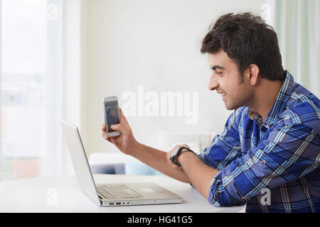 Smiling man having video calling on phone Stock Photo