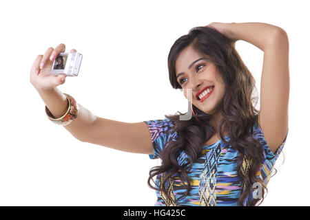 Young woman taking self photo with camera Stock Photo