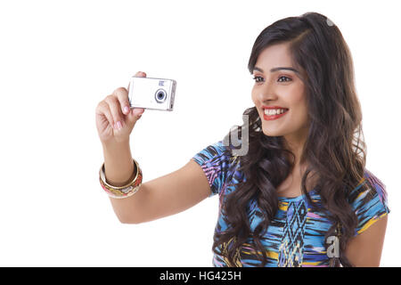 Young woman taking self photo with camera Stock Photo