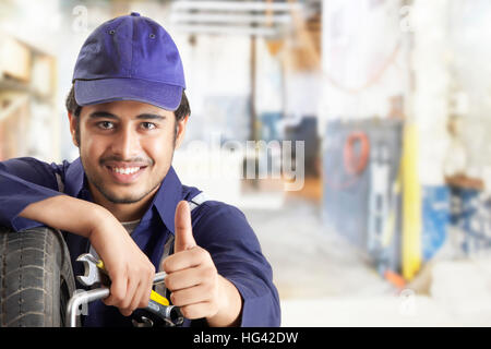 Portrait of car mechanic showing thumbs up Stock Photo