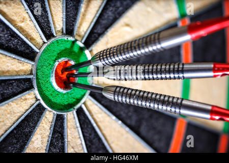 three darts in bull's eye, close up Stock Photo