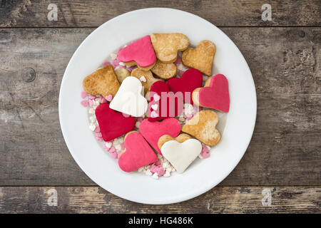 Valentine cookies with heart shape in plate on wooden background Stock Photo