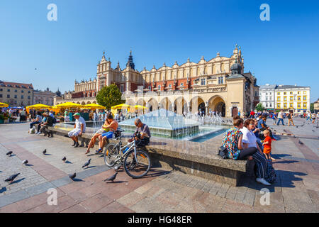 KRAKOW, POLAND - September 16, 2016: Tourists enjoying an summer day in The Grand Central Square in front of the The Renaissance Sukiennice also known Stock Photo
