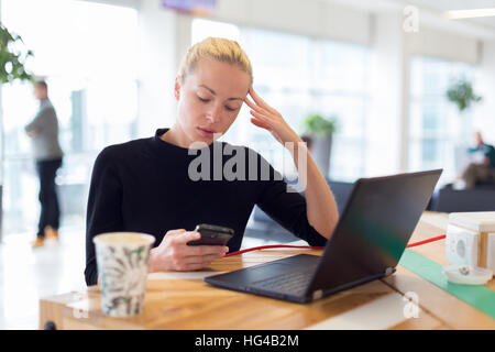 Female freelancer remotely working on the go. Stock Photo