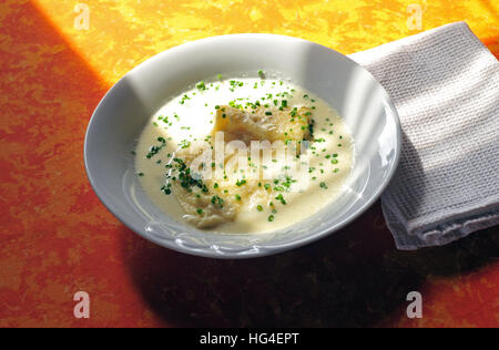 Cottage cheese dumplings in whey soup and chives on top Stock Photo