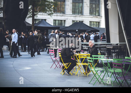 London lunch break outside the Gherkin. People waiting in row to the different street food stalls Stock Photo