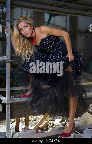 Fashion model posing on building site Stock Photo