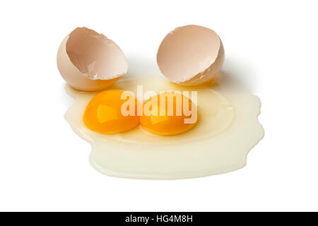 Broken raw double yolk egg isolated on white background Stock Photo
