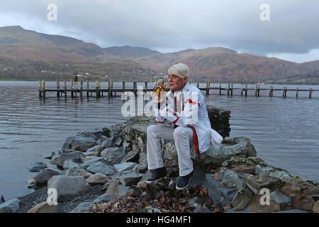 Gina Campbell, the daughter of world land and water speed record holder Donald Campbell, holds his mascot, a teddy bear named Mr Whoppit, as she marks the 50th anniversary of the fatal crash there of his jet-powered Bluebird boat at Lake Coniston. Stock Photo