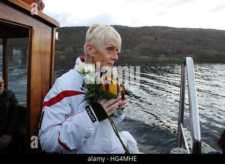 Gina Campbell, the daughter of world land and water speed record holder Donald Campbell, holds his mascot, a teddy bear named Mr Whoppit, as she marks the 50th anniversary of the fatal crash there of his jet-powered Bluebird boat at Lake Coniston. Stock Photo