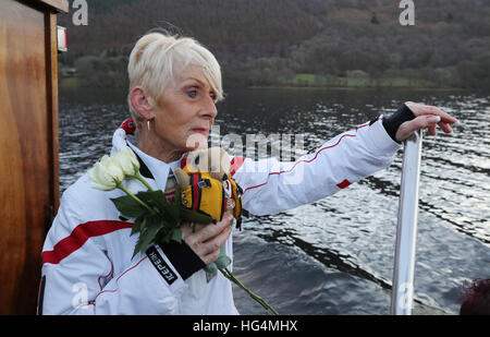 Gina Campbell, the daughter of world land and water speed record holder Donald Campbell, holds his mascot, a teddy bear named Mr Whoppit, as she marks the 50th anniversary of the fatal crash there of his jet-powered Bluebird boat at Lake Coniston. Stock Photo