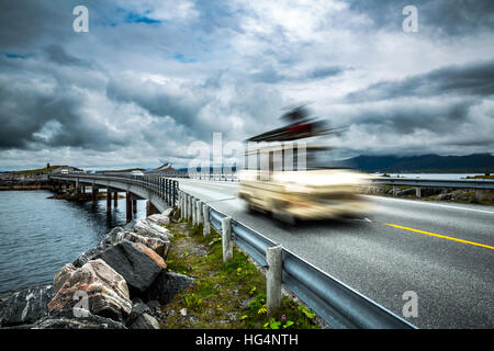 Car travels on the highway. Caravan Car in motion blur. Norway. Atlantic Ocean Road or the Atlantic Road (Atlanterhavsveien) been awarded the title as Stock Photo