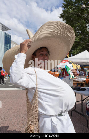Hispanic man in big belly (fat belly) costume at an outdoor event - USA Stock Photo