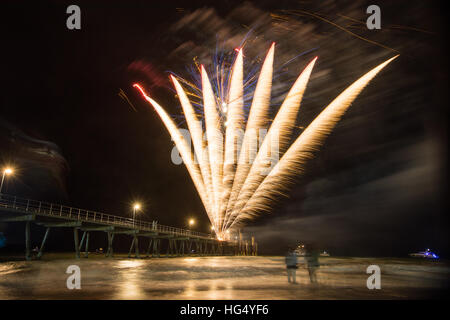 Colourful 2017 New Years Fireworks Display lighting up the sky and water off Glenelg Jetty, Adelaide, South Australia Stock Photo