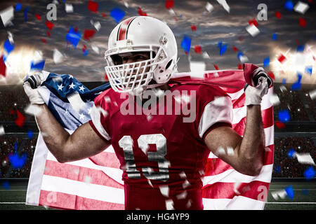 Football Player with a red uniform celebrating, on a stadium. Stock Photo