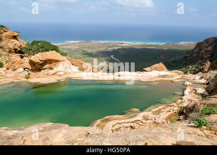 Homhil (Socotra Isalnd), Yemen - 13 January 2008: man sitting on the lakeside of Homhil mountain lake on Socotra island, Yemen Stock Photo