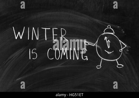 winter is coming handwritten on a chalkboard with chalk Stock Photo