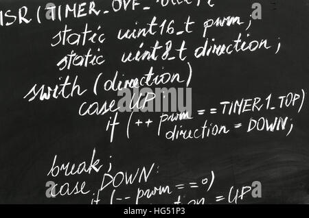 A detail of computer code in AVR explained with white chalk Stock Photo