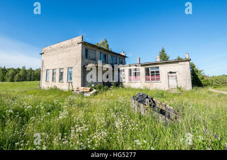 Old and abandoned building stands in the middle of the field Stock Photo
