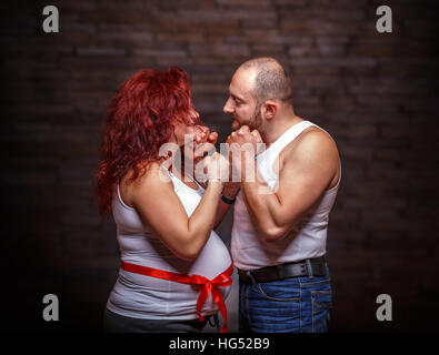 Portrait of expecting couple, studio shot Stock Photo