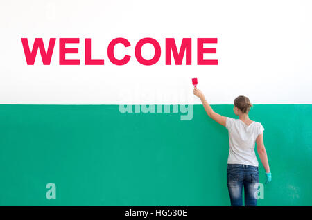 On the white wall with paint write Welcome Stock Photo