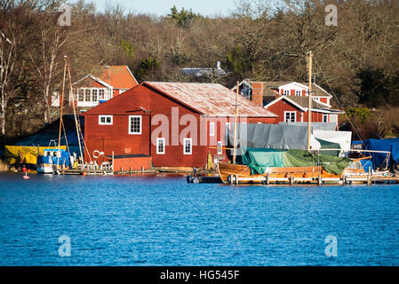 Ronneby, Sweden - January 2, 2017: Documentary of Swedish coastal lifestyle. The old shipyard at Saxemara bay as seen from across the water. Stock Photo